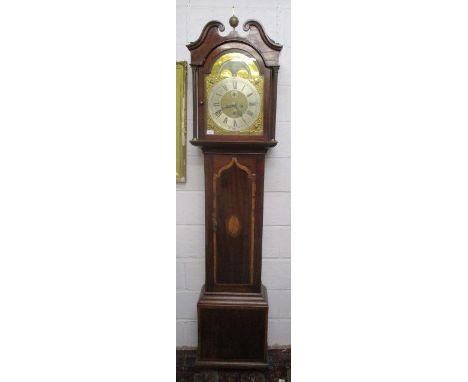 A George III  mahogany 8 day longcase clock. The case having a broken swan neck pediment and brass finial. The brass dial hav