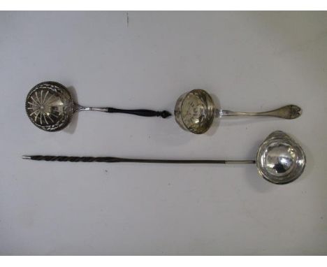 Two silver sugar sifter ladles, one marked Svenson and the other DWK, on a turned wooden handle and a white metal toddy ladle