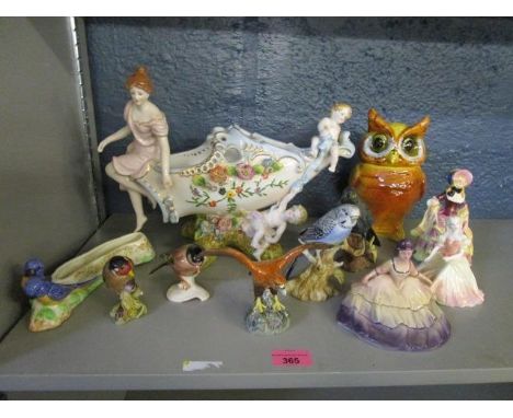 A group of ceramic figurines and bird models to include a German flower bowl decorated with encrusted flower heads and cherub