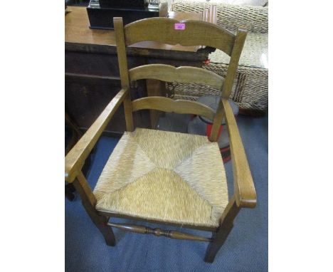 A set of six oak ladder back and rush seated dining chairs and two matching carvers 
