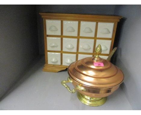 A small pine herb cabinet having twelve ceramic herb drawers, together with a copper and brass soup tureen with a matching la