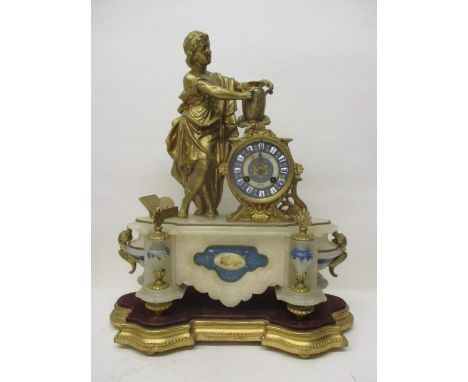 A  late 19th century French gilt metal and marble mantle clock decorated with a classical figure decorating an urn, standing 