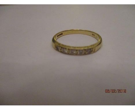 An 18ct gold half eternity band inset with five small diamonds, total weight 2.78g 