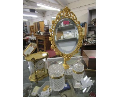 A cut glass and gilt metal dressing table mirror and two matching pots, along with a German mantle clock 