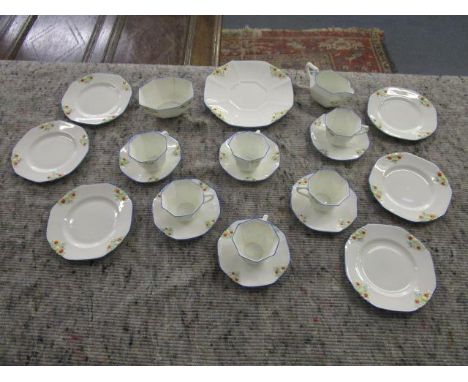 A Royal Doulton part tea set decorated with little flower heads in red, yellow and light blue 