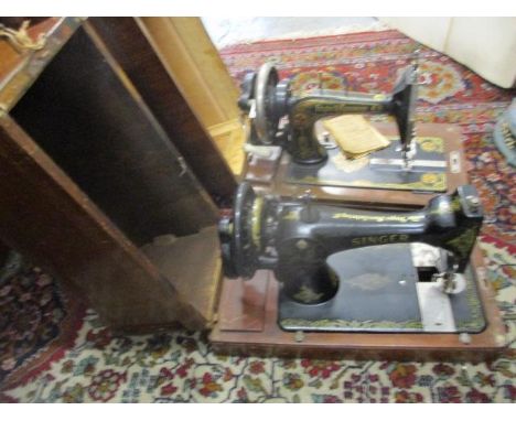 Two manual sewing machines in mahogany finished cases, one being a Singer 