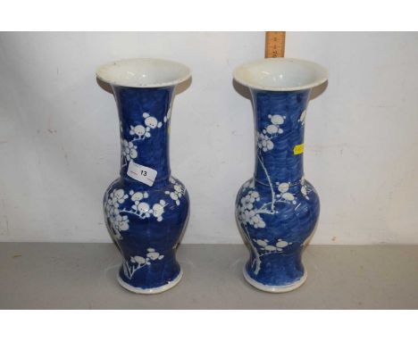 A pair of Chinese prunus pattern blue and white vases with circular ring marks to base