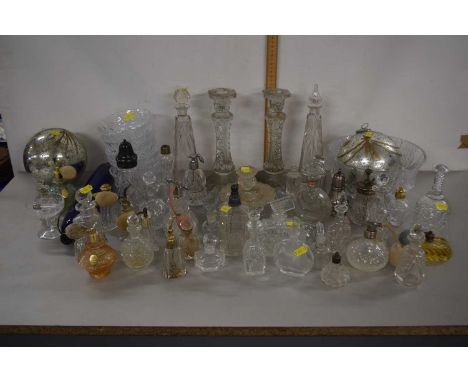 A collection of various glass perfume bottles, dressing table jars, candlesticks, large glass baubles, glass rolling pin etc