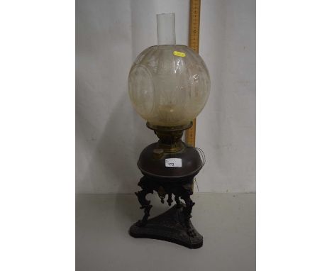 Victorian oil lamp with cast metal three footed base