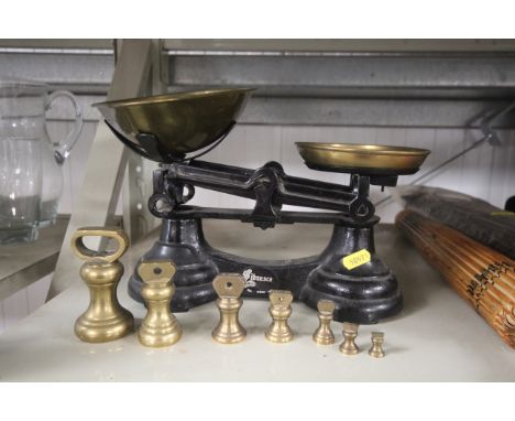 A set of cast iron and brass kitchen scales and weights