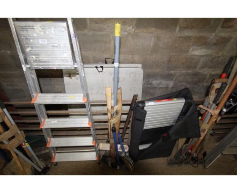 A quantity of tools to include pipe bender, axe, broom, shooting stick etc.