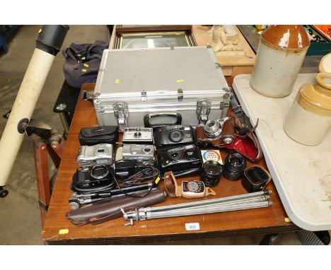 A quantity of various cameras and accessories with a camera flight case
