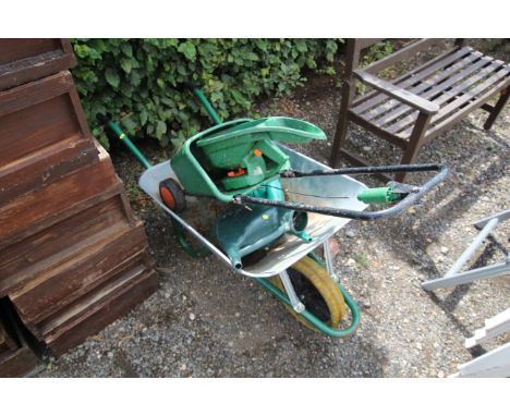 A light weight galvanised garden wheel barrow and contents of seed spreaders and two watering cans