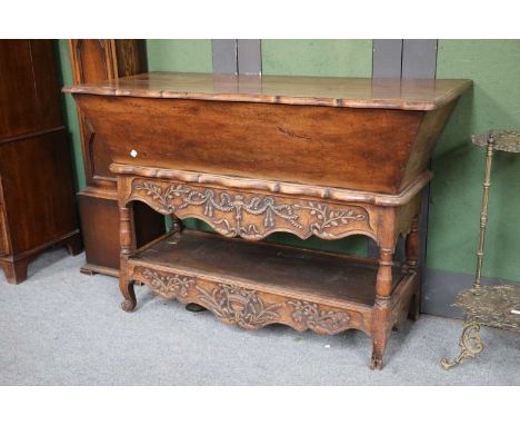 A Carved Oak Dough Bin on Stand, 18th century, with shaped top, on a conforming base with carved aprons and shelf stretcher, 