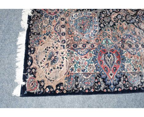 Kashmar Carpet, East Iran, the indigo field of vines and urns centred by a flower head medallions enclosed by floral borders,