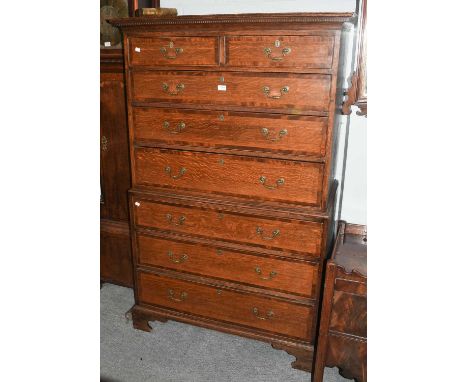 A George III Oak Chest on Chest, crossbanded in mahogany, with cock beading and raised on bracket feet, 102cm by 52cm by 172c