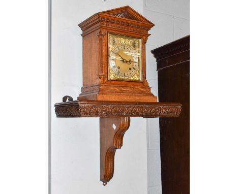 A German Oak Cased Chiming Table Clock, with architectural pediment, the 7 inch brass dial with fast/slow and chime/silent se