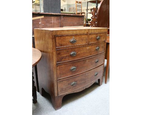 A George III Mahogany Crossbanded Four Height Bowfront Chest of Drawers, on bracket feet, 97cm by 50cm by 99cm