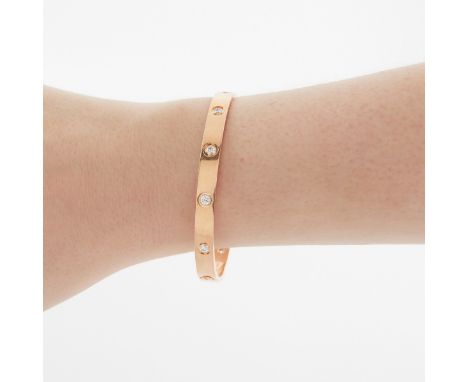 Cartier, France. 18k yellow gold LOVE bracelet inset with ten brilliant cut diamonds. Each diamond measuring approximately 3.