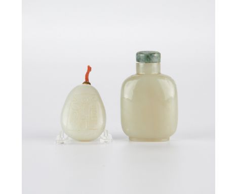 Group of two Chinese Qing dynasty pale jade snuff bottles. One well-hallowed rounded bottle with carvings along both sides an