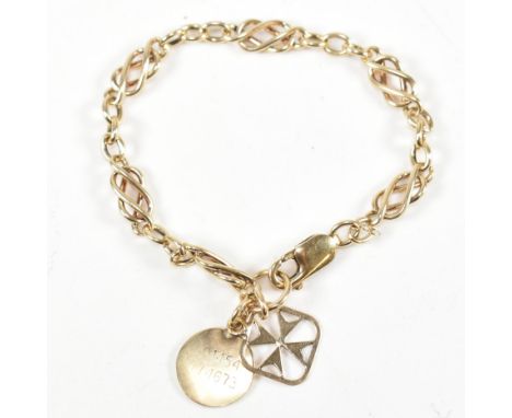 A 9ct gold chain bracelet with hallmarked 9ct gold Maltese cross charm. The 9ct yellow gold fancy link chain bracelet with a 