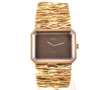 A 1970s Omega De Ville 8272 18ct gold wristwatch by Gilbert Albert. The watch having a naturalistic strap with fold-over snap