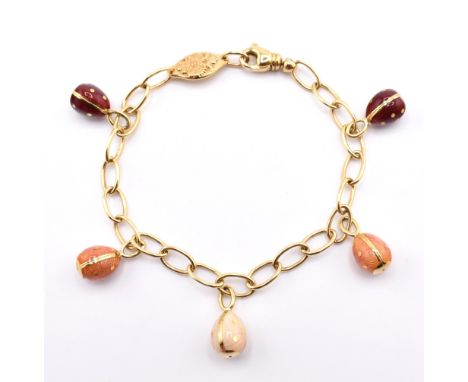 A Fabergé 18ct gold egg charm bracelet. The bracelet strung with five enamelled egg charms. Hallmarked London. Total weight 2