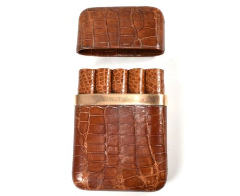 A hallmarked 9ct gold mounted John Pound & Co cigar case. The John Pound & Co cigar pocket case having a brown crocodile leat