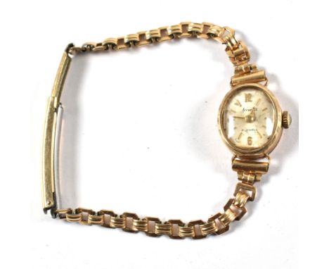 A 9ct gold vintage ladies cocktail/dress watch. The champagne dial with baton markers, marked for Rotary. Set in 9ct gold hal