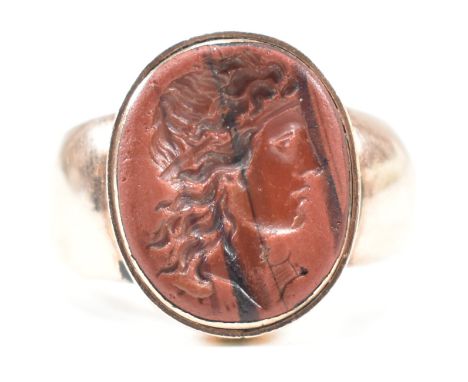 A 19th century intaglio seal ring. The ring having an oval lava intaglio depicting the profile of a man facing right to taper