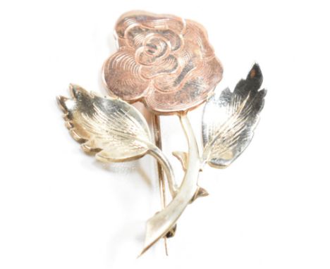 A hallmarked 9ct bi-colour gold brooch pin in the form of a rose. The brooch having a hinge pin and roller clasp verso. Hallm