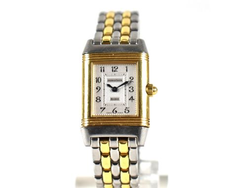 A Jaeger LeCoultre Reverso Duetto 18ct gold diamond and stainless steel wristwatch. The watch having two dials, a silver dial