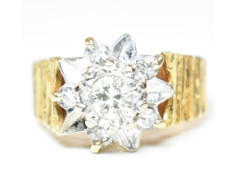 A vintage hallmarked 18ct gold and diamond cluster ring. The ring having a central round brilliant cut diamond, estimated 0.2