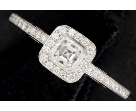 a 0,30 carat very high quality cushion cut diamond set in a very nice fashionable ring in white gold (18 carat) with at least