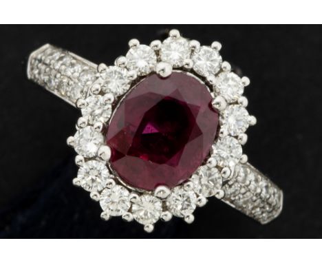 ring in white gold (18 carat) with an oval 1,67 carat ruby surrounded by 1,10 carat of very high quality brilliant cut diamon