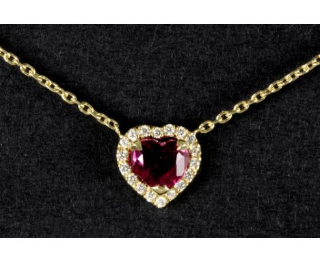 pendant in yellow gold (18 carat) with a 0,72 carat intense red and transparent ruby, surrounded by ca 0,10 carat high qualit