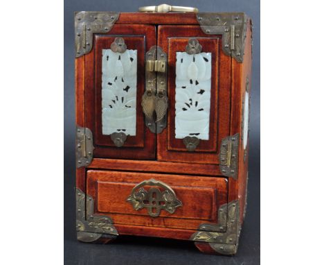 A 20th Century Chinese hardwood and jade panel set jewellery cabinet box. The cabinet having twin doors set with carved jade 