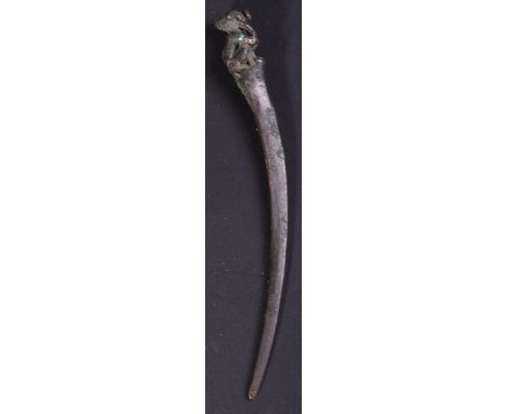 A Roman bronze ladies hairpiece / hair pin. Long curved blade with figural depiction to the terminal / handle. Measures appro