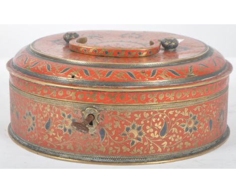 An early 20th Century Persian Islamic metal spice box container. Brass scrollwork with red &amp; cobalt enamel paint. The lid