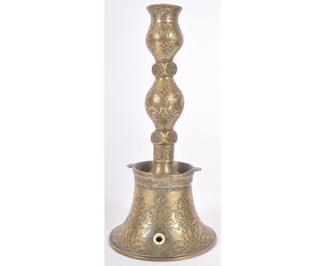 A 19th Century Persian Islamic engraved brass candlestick. Engraved baluster column with engraved bell shaped base. Converted