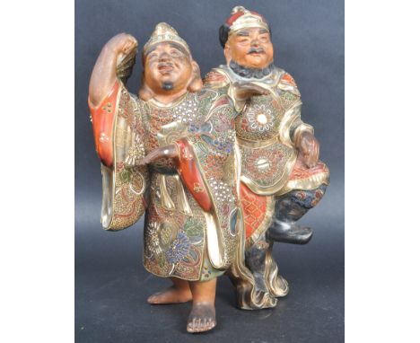 An early 20th Century Japanese / Oriental gilded porcelain / ceramic Satsuma Figure. Depicting two men side by side in ornate
