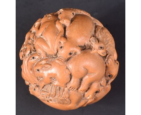 An early 20th Century Japanese hand carved netsuke in the form of a ball. Profusely carved depicting various Zodiac animals. 