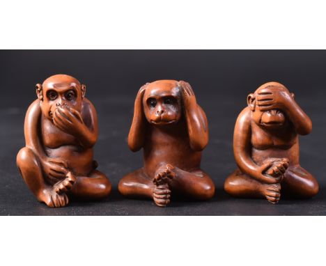 A set of three 20th Century Japanese hand carved wooden netsuke figurines in the form of the three wise monkeys. Each signed.