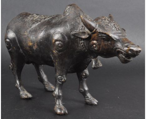 An early 20th Century Indian Hindu bronze cast model in the form of a sacred cow. The figure modelled standing with hump to n
