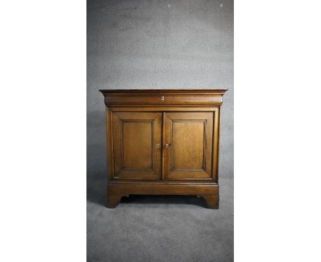 A 19th century French Provincial oak side cabinet with frieze drawer above panel doors on bracket feet. H.110 W.114 D.50 (Wit