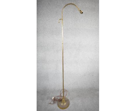 A vintage solid brass height adjustable arched design standard lamp with weighted circular base and silk wrapped cord. H.177 
