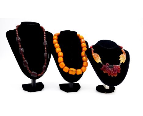 A butterscotch amber necklace with silver hook fastening, indistinct hallmarks, composed of twenty three polished barrel shap