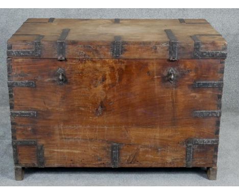 A 19th century iron bound camphor travelling trunk with twin metal carrying handles on shaped supports. H.72 W.102 D.61cm 
