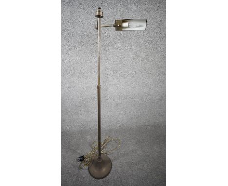 A vintage solid brass height adjustable swing arm floor lamp with triangular shade and circular weighted base. Two pin plug. 