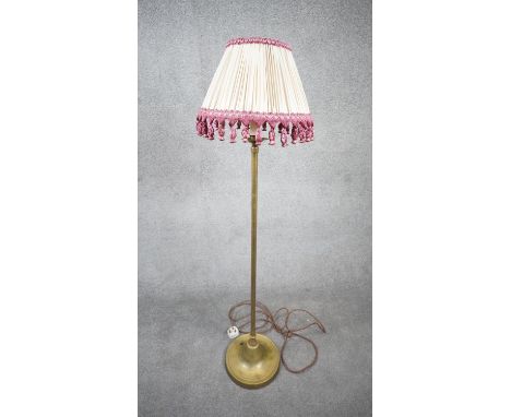 A vintage solid brass weighted base height adjustable standard lamp with silk wrapped cord and pink tassel cream pleated silk